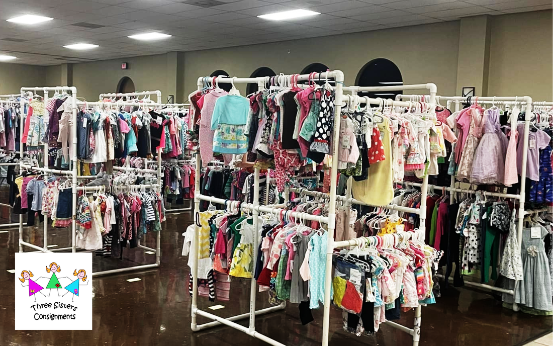 clothing racks filled with children's clothing at the sale.
